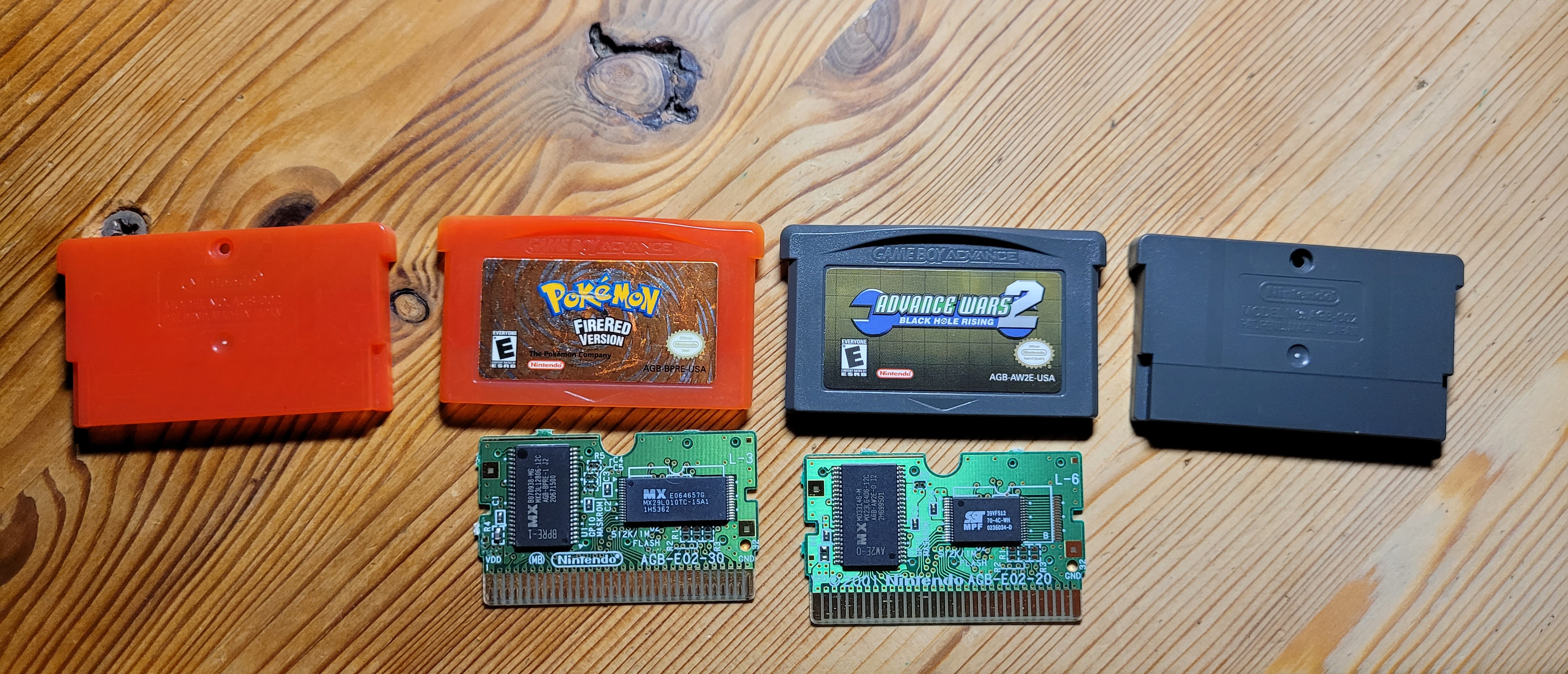 View of two GBA game catriges opened up with exposed PCBs side by side