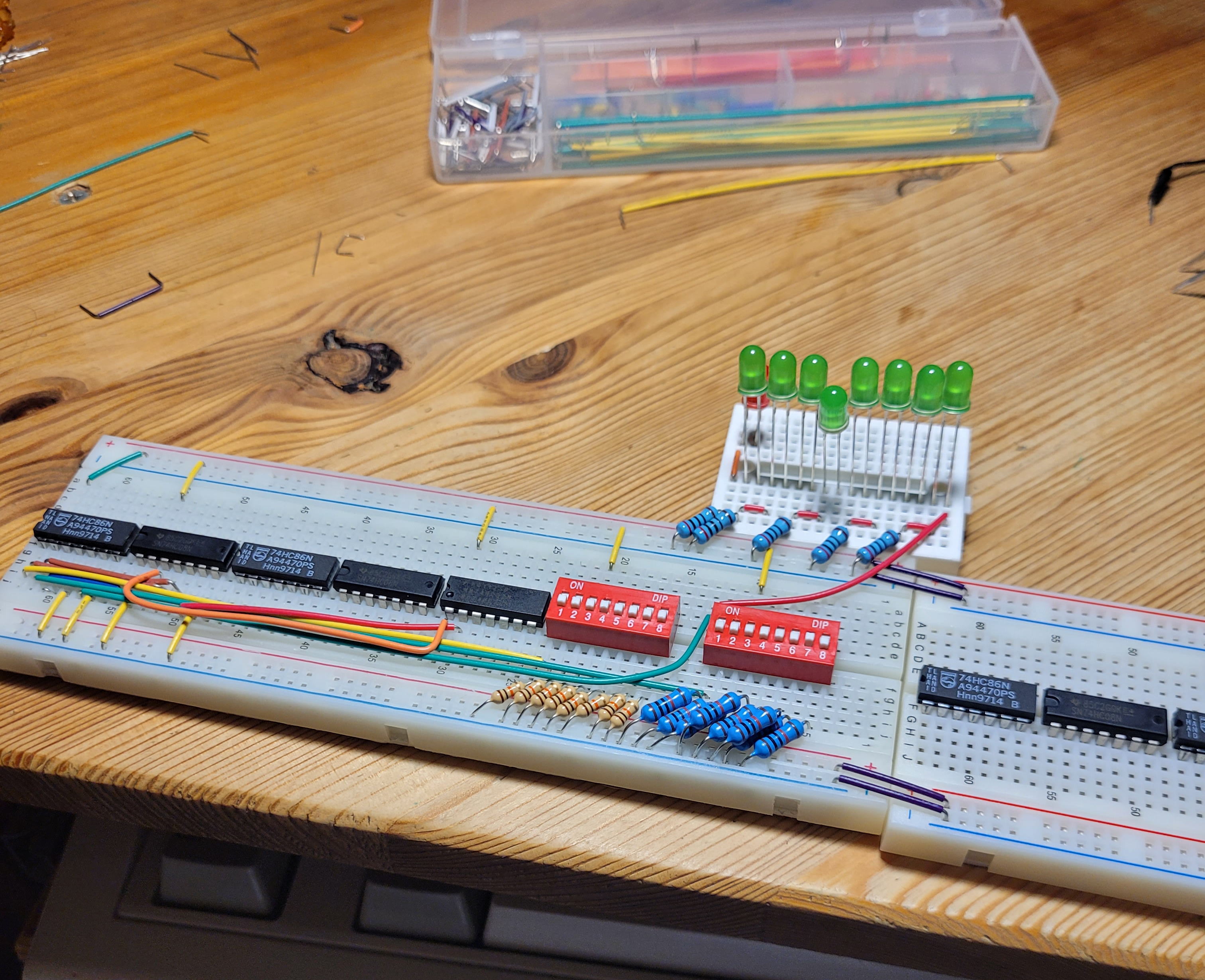 Image of all the ICs and DIP switches placed and a single full adder completed.